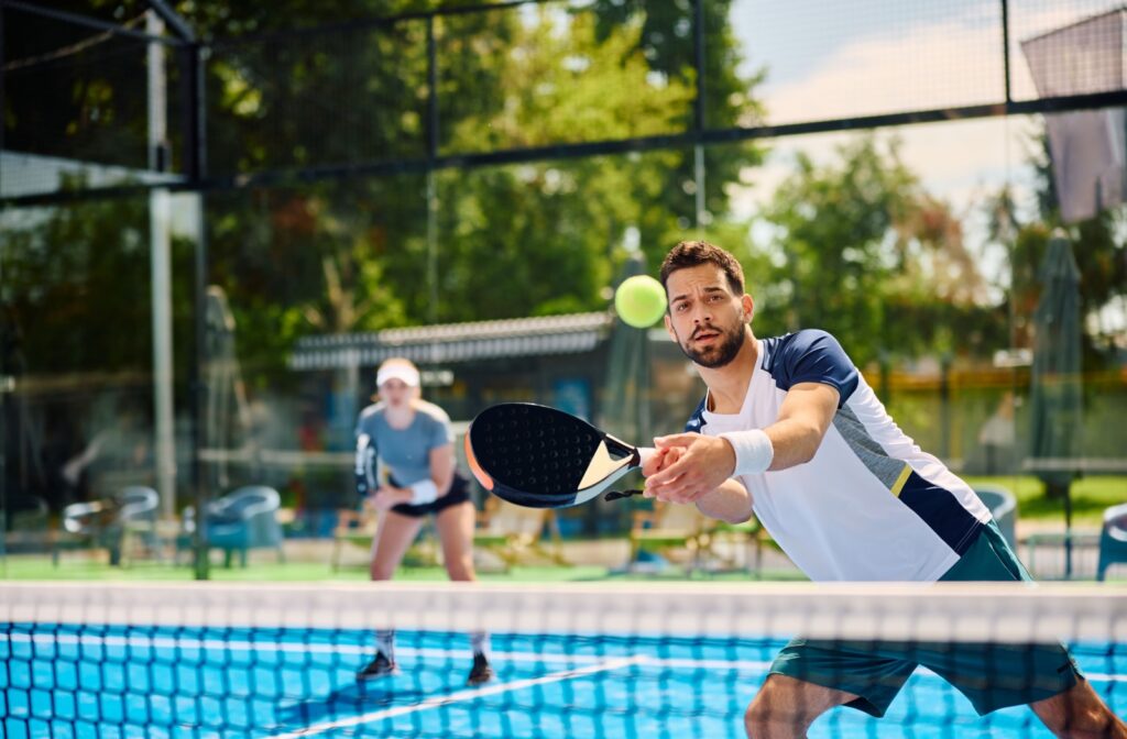 A person using their visual motor skils to play a racket sport.