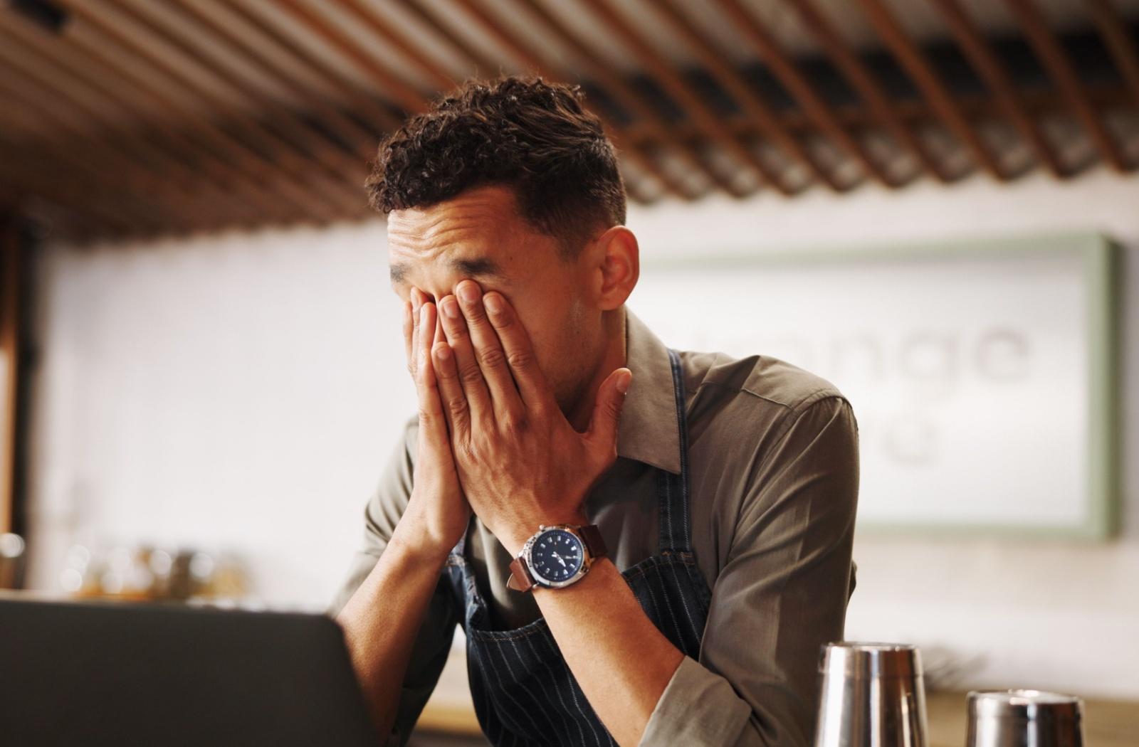 A person rubbing their eyes due to eye problems that have developed due to age.